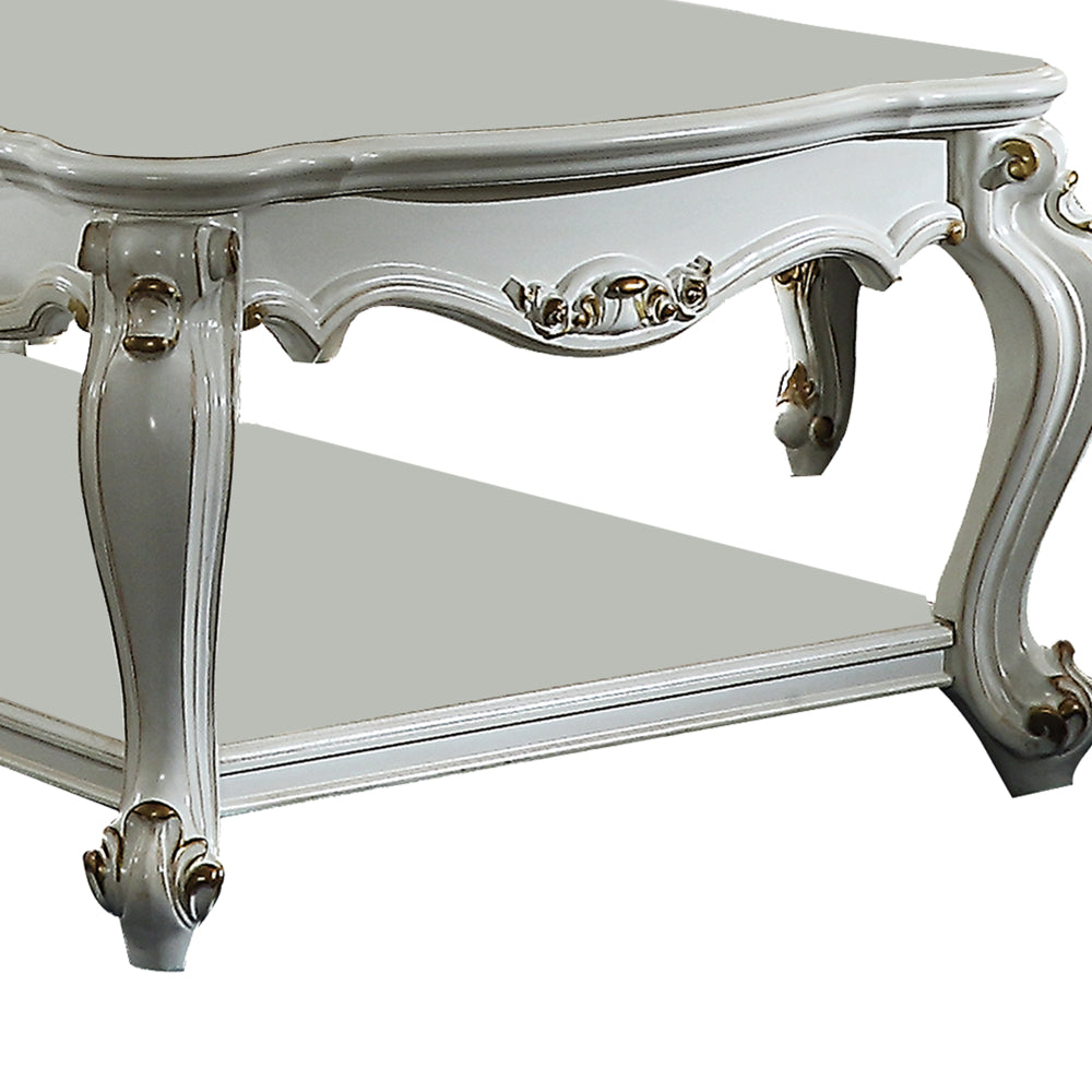 Traditional Style Wooden Coffee Table with Polyresin Carvings and Bottom Shelf, White By Casagear Home