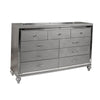 9 Drawer Wooden Dresser with Embossed Texture and Mirror Accents, Silver By Casagear Home