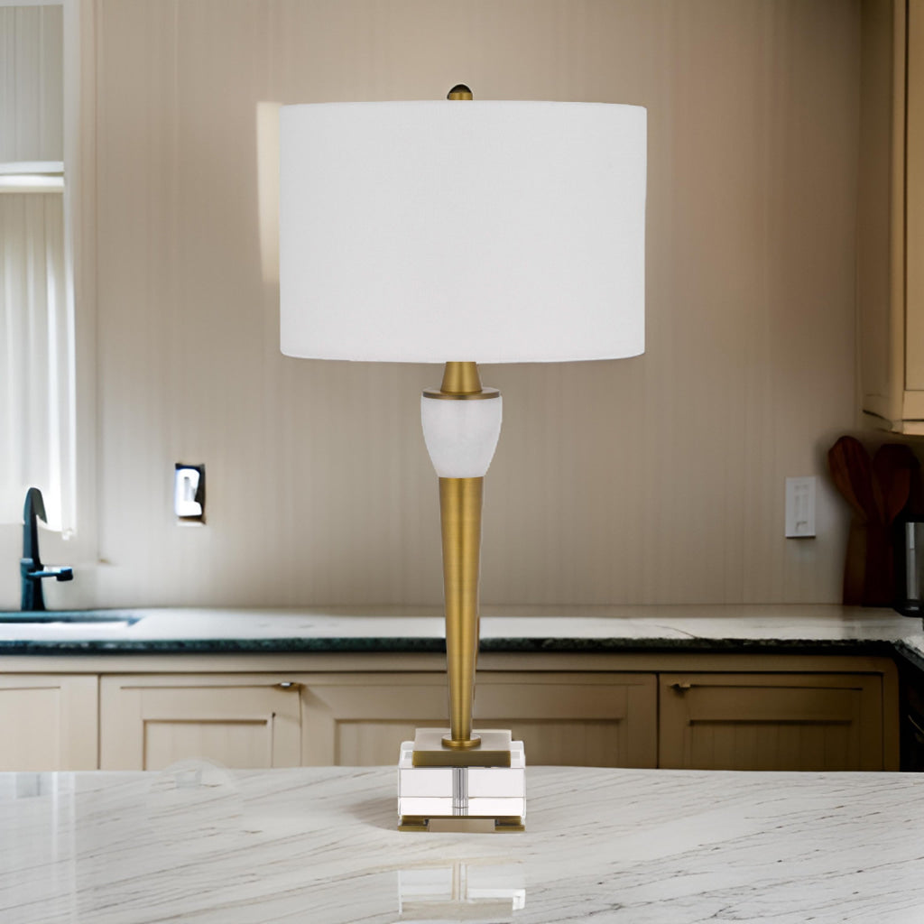 31 Inch Table Lamp with White Drum Shade, Clear Crystal Base, Brass Finish By Casagear Home