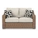 Ashley Tira Outdoor Loveseat 57 Inch Handwoven Resin Wicker Beige Pillows BM328961