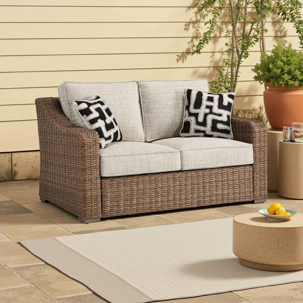 Ashley Tira Outdoor Loveseat, 57 Inch Handwoven Resin Wicker, Beige, Pillows