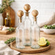 Hazie Decorative Glass Bottles Set of 3 | Mango Wood Stoppers 16 & 18"