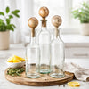 Hazie Decorative Glass Bottles Set of 3 | Mango Wood Stoppers 16 & 18"