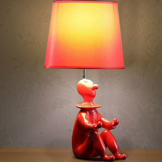 Fabric Shade Table Lamp with Polyresin Sitting Clown Base, Red By Casagear Home